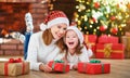 Happy family mother and daughter giving christmas gift