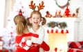 Happy family mother and daughter giving christmas gift Royalty Free Stock Photo