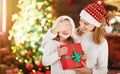Happy family mother and daughter giving christmas gift Royalty Free Stock Photo