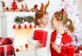 Happy family mother and daughter giving christmas gift Royalty Free Stock Photo