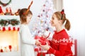 Happy family mother and daughter giving christmas gift Royalty Free Stock Photo