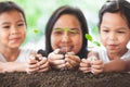 Happy family mother and daughter holding young tree Royalty Free Stock Photo