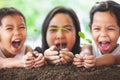 Happy family mother and daughter holding young tree Royalty Free Stock Photo