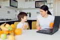 Happy family mother and daughter little girl, eat healthy vegetarian food, lots of fruit Royalty Free Stock Photo