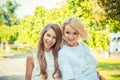 Happy family. mother and daughter looking at you camera smiling isolated outdoors outside green park background Royalty Free Stock Photo