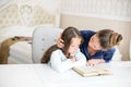 Happy family mother and daughter read a book in the evening at home. the concept of family comfort and family relations Royalty Free Stock Photo