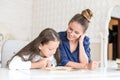 Happy family mother and daughter read a book in the evening at home. the concept of family comfort and family relations Royalty Free Stock Photo