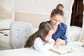 Happy family mother and daughter read a book in the evening at home. the concept of family comfort and family relations Royalty Free Stock Photo