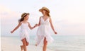 Happy family mother and daughter running in beach Royalty Free Stock Photo