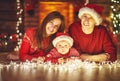 Happy family mother father and baby at christmas tree at home Royalty Free Stock Photo