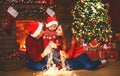 Happy family mother father and baby at christmas tree at home Royalty Free Stock Photo