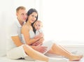 Happy family, mother and father with baby home in white room Royalty Free Stock Photo