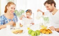 Happy family mother, father, child baby daughter having breakfast Royalty Free Stock Photo