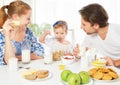 Happy family mother, father, child baby daughter having breakfast Royalty Free Stock Photo