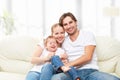 Happy family mother, father, child baby daughter at home on sofa playing and laughing Royalty Free Stock Photo