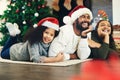 Happy family, mother and father with child for Christmas celebration while relaxing on living room floor at home. Mom Royalty Free Stock Photo