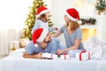 Happy family mother father and child on Christmas morning in bed Royalty Free Stock Photo