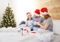 Happy family mother father and child on Christmas morning in bed Royalty Free Stock Photo