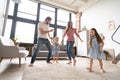 Happy family mother father and child daughter dancing at home. Royalty Free Stock Photo
