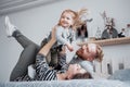 Happy family mother, father and child daughter laughs in bed Royalty Free Stock Photo