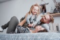 Happy family mother, father and child daughter laughs in bed Royalty Free Stock Photo