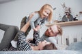 Happy family mother, father and child daughter laughs in bed Royalty Free Stock Photo