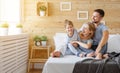 Happy family mother, father and child laughs in bed Royalty Free Stock Photo