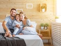 Happy family mother, father and child laughs in bed Royalty Free Stock Photo