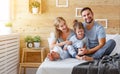 Happy family mother, father and child laughs in bed Royalty Free Stock Photo