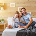 Happy family mother, father and child laughs in bed Royalty Free Stock Photo