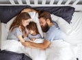 Happy family mother, father and child sleeping in bed Royalty Free Stock Photo