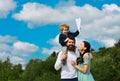 Happy family mother father and child son laughing and havig fun with toy paper plane. Child playing with toy airplane Royalty Free Stock Photo