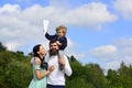 Happy family mother father and child son laughing and havig fun with toy paper plane. Child playing with toy airplane Royalty Free Stock Photo