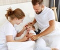 Happy family mother, father and child son laughing, playing, fights pillows and jumping in bed   at home Royalty Free Stock Photo