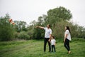 Happy family: mother father and child son on nature on sunset. Mom, Dad and kid laughing and hugging, enjoying nature Royalty Free Stock Photo