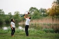Happy family: mother father and child son on nature on sunset. Mom, Dad and kid laughing and hugging, enjoying nature outside. Royalty Free Stock Photo