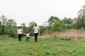 Happy family: mother father and child son on nature on sunset. Mom, Dad and kid laughing and hugging, enjoying nature outside. Royalty Free Stock Photo