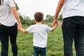 Happy family: mother father and child son on nature on sunset. Mom, Dad and kid laughing and hugging, enjoying nature outside. Royalty Free Stock Photo