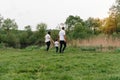 Happy family: mother father and child son on nature on sunset. Mom, Dad and kid laughing and hugging, enjoying nature outside. Royalty Free Stock Photo