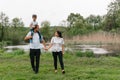 Happy family: mother father and child son on nature on sunset. Mom, Dad and kid laughing and hugging, enjoying nature outside. Royalty Free Stock Photo