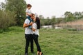 Happy family: mother father and child son on nature on sunset. Mom, Dad and kid laughing and hugging, enjoying nature outside. Royalty Free Stock Photo