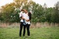 Happy family: mother father and child son on nature on sunset. Mom, Dad and kid laughing and hugging, enjoying nature outside. Royalty Free Stock Photo