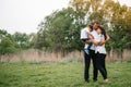 Happy family: mother father and child son on nature on sunset. Mom, Dad and kid laughing and hugging, enjoying nature outside. Royalty Free Stock Photo