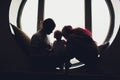 happy family of mother, father and child son playing and cuddling at home on floor near a big window. Royalty Free Stock Photo