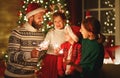 Happy family mother, father and children celebrate Christmas   light sparklers Royalty Free Stock Photo