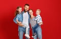 Happy family mother father and children daughter and son  near an   red wall Royalty Free Stock Photo