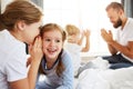 Happy family mother, father and children laughing, playing and talk in bed   at home Royalty Free Stock Photo