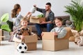 Happy family mother father and children move to new apartment and unpack boxes Royalty Free Stock Photo