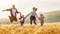 Happy family: mother, father, children son and daughter jumping on sunset Royalty Free Stock Photo