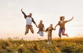 Happy family: mother, father, children son and daughter jumping on sunset Royalty Free Stock Photo